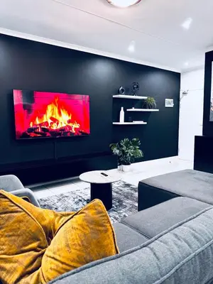 a living room with a fire in the wall at The Blyde Pretoria 2 bed 2 bath apartment in Pretoria