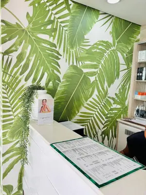 a white counter with green leaves on a wall at The Blyde Pretoria 2 bed 2 bath apartment in Pretoria