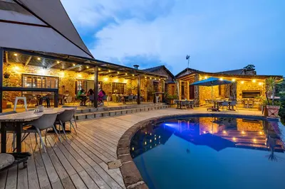 a house with a swimming pool and a patio at Misty Mountain in Sabie