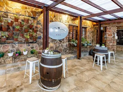 a wine tasting room with two barrels and stools at Misty Mountain in Sabie