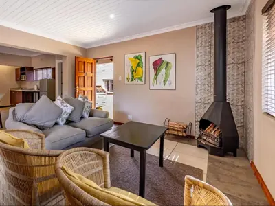 a living room with a couch and a fireplace at Misty Mountain in Sabie