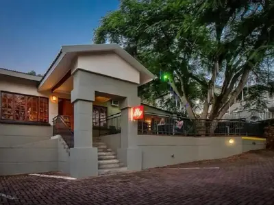 a building with a sign on the side of it at Sabores Lodge and Restaurant in Nelspruit