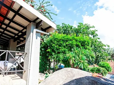 a view of a house with trees and a rock at Sabores Lodge and Restaurant in Nelspruit