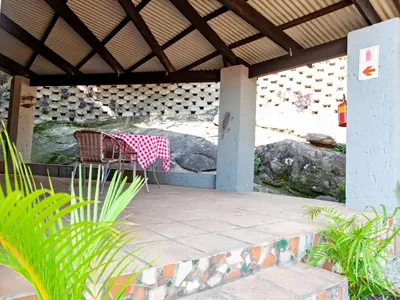 a table and chair sitting on a patio at Sabores Lodge and Restaurant in Nelspruit