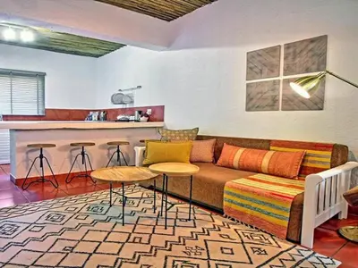 a living room with a couch and a bar at Sabores Lodge and Restaurant in Nelspruit