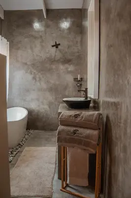 a bathroom with a sink and a bath tub at The Hyde in Marloth Park