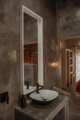 a bathroom with a sink and a mirror at The Hyde in Marloth Park