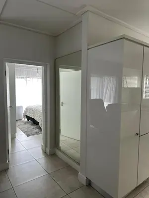 a room with a mirrored closet and a bedroom at Home at Polo - Classy Comfort in Midrand