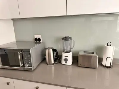 a kitchen counter with a microwave and a blender at Home at Polo - Classy Comfort in Midrand