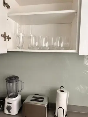 a kitchen counter with a blender and glasses on a shelf at Home at Polo - Classy Comfort in Midrand