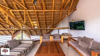 a living room with couches and a wooden ceiling at Zebula Golf and Wildlife Estate - Tuskers Retreat Pax 20 in Warmbaths