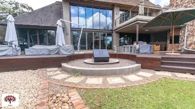 a house with a fountain in front of a building at Zebula Golf and Wildlife Estate - Tuskers Retreat Pax 20 in Warmbaths