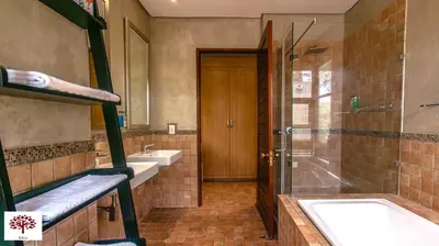 a bathroom with a tub and a sink and a shower at Zebula Golf and Wildlife Estate - Tuskers Retreat Pax 20 in Warmbaths