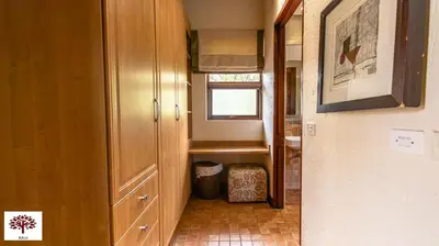 a hallway leading to a bathroom with a small window at Zebula Golf and Wildlife Estate - Tuskers Retreat Pax 20 in Warmbaths