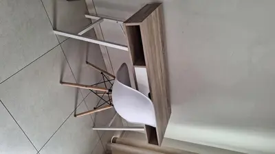 a staircase with a white chair in a room at The Luxury Apartments in Midrand