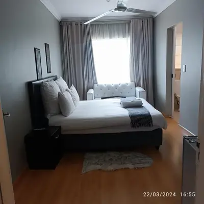 a bedroom with a large bed and a window at Glen Rest Country Lodge in Midrand