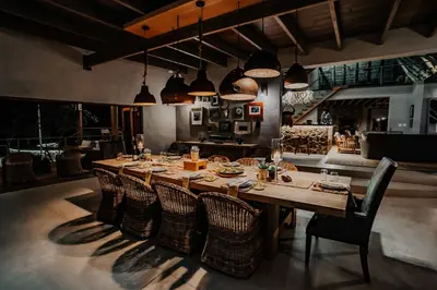 a dining room with a long table and chairs at Bongela Private Game Lodge in Vaalwater