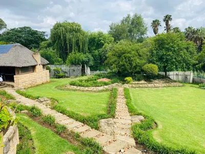 a garden with a stone path in a yard at The Adress in Midrand