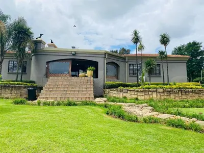 a house with palm trees in front of it at The Adress in Midrand