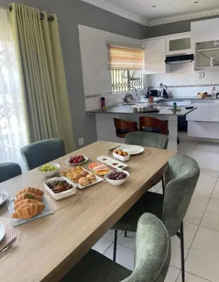 a wooden table with food on it in a kitchen at Kings view exclusive villas in Petronella