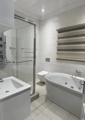 a bathroom with a tub and a sink and a toilet at Kings view exclusive villas in Petronella