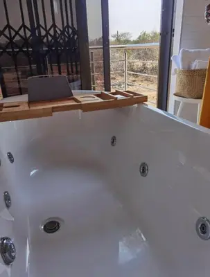 a bath tub with a laptop on top of it at Kings view exclusive villas in Petronella