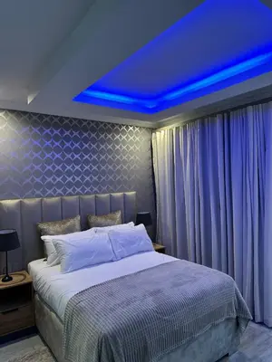 a bedroom with a bed with a blue ceiling at Nouvelle Ere Beauty Spa & Boutique Guesthouse in Centurion