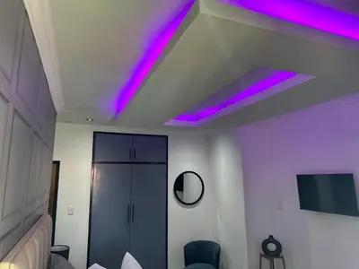 a room with purple lights on the ceiling at Nouvelle Ere Beauty Spa & Boutique Guesthouse in Centurion