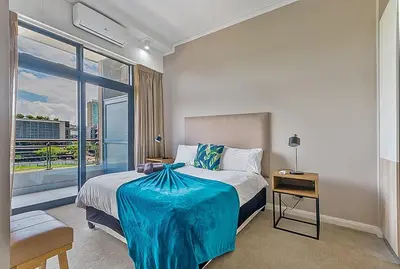 a bedroom with a bed and a large window at Capital Residence Apartment in Menlyn Maine in Pretoria