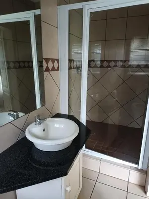 a bathroom with a sink and a shower at Riverside Lodge - Loerie in Cobalt