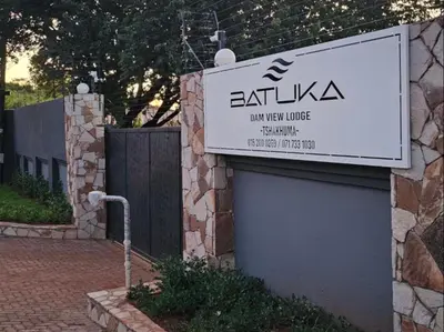a sign for the entrance to a building at Batuka Damview Lodge in Tshakhuma