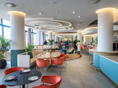 a restaurant with tables and chairs and a bar at Ellipse Kepler High-Rise 2-Bedroom en-suite Luxury Apartment in Midrand