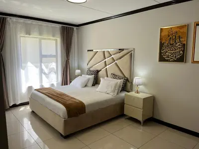 a bedroom with a large bed and a window at Lake view Apartment and suite in Midrand