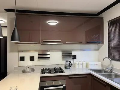 a kitchen with a sink and a stove top oven at Lake view Apartment and suite in Midrand