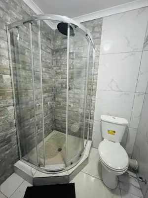a shower in a bathroom with a toilet at Mohwelere Guest House in Pretoria