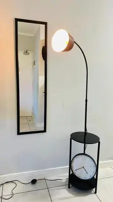 a black lamp sitting in front of a mirror at House of sebo in Pretoria