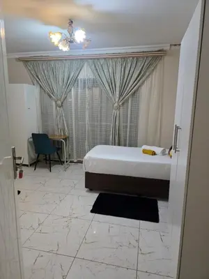 a bedroom with a bed and a large window at AB Lisi Accommodation in Pretoria