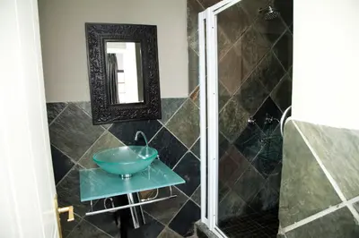 a bathroom with a sink and a mirror at The Gables Middelburg MPU in Middelburg