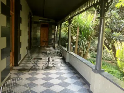 a porch of a house with chairs and a table at The Gables Middelburg MPU in Middelburg
