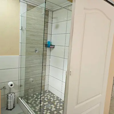a shower with a glass door in a bathroom at The Luxury stay in Midrand