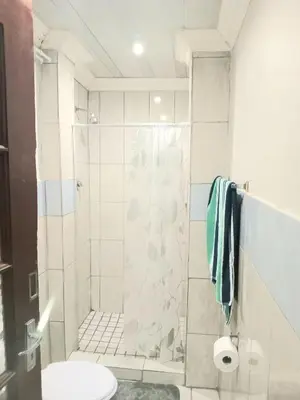 a bathroom with a shower and a toilet at Kama house in Pretoria