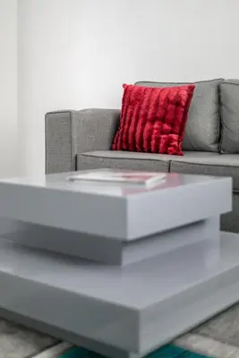 a living room with a couch and a red pillow at The Golden Place in Kempton Park