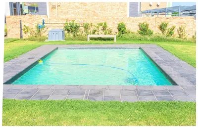 a pool with a ball in the middle of a yard at Time out Main in Pretoria