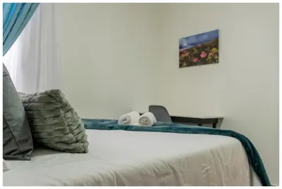a bedroom with a bed and a window at Time out Main in Pretoria