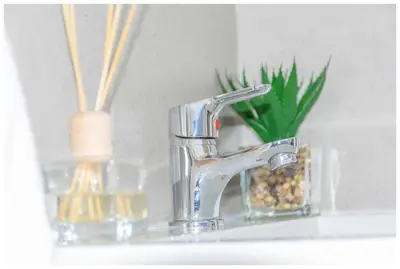 a bathroom sink with a faucet and a mirror at Time out Main in Pretoria