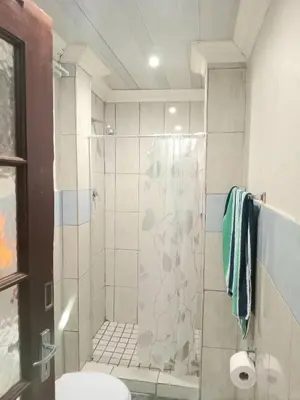 a bathroom with a shower and a toilet at Kama B&B in Pretoria