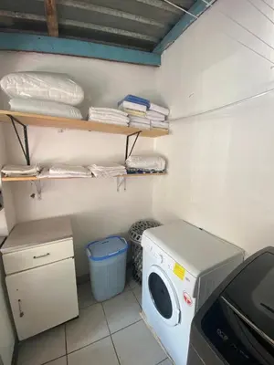 a laundry room with a washer and a washing machine at Bennyz Guest House in Pretoria