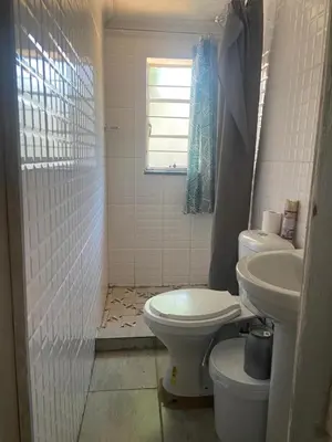 a bathroom with a toilet and a sink at Bennyz Guest House in Pretoria