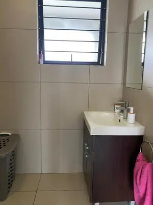 a bathroom with a sink and a mirror at Where every guest feels special in Midrand