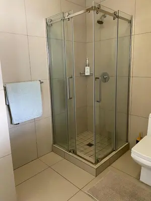 a shower with a glass door in a bathroom at Where every guest feels special in Midrand